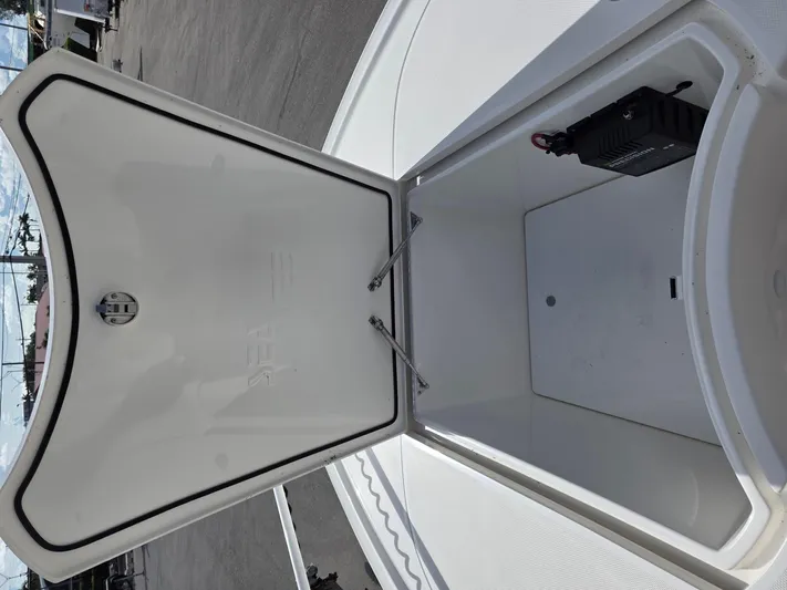 Seavee Yacht Photos Pics Open storage compartment on 2023 SeaVee 270Z boat, showcasing interior space.
