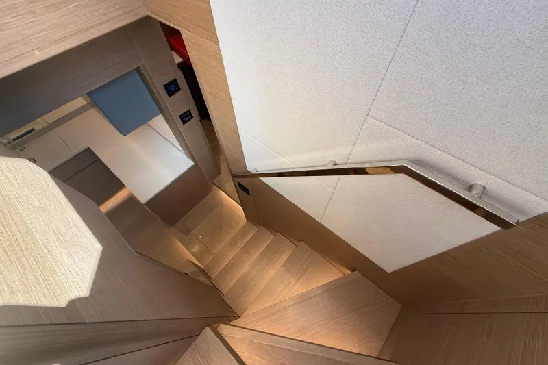  Yacht Photos Pics Interior staircase of 2026 Pardo Yachts GT75, featuring modern wood design and sleek handrail.