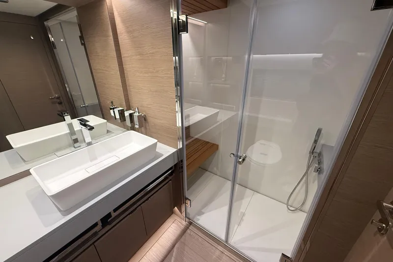 Yacht Photos Pics Luxurious bathroom in 2026 Pardo Yachts GT75, featuring modern sink and glass shower.