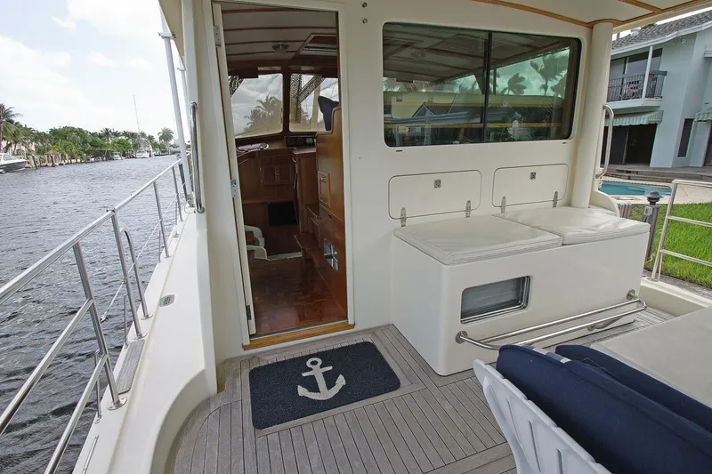 Just Right Yacht Photos Pics 2004 Dettling Express Cruiser deck with seating and nautical decor by the water.