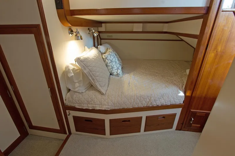Just Right Yacht Photos Pics Cozy cabin interior of 2004 Dettling Express Cruiser with bed and wooden accents.