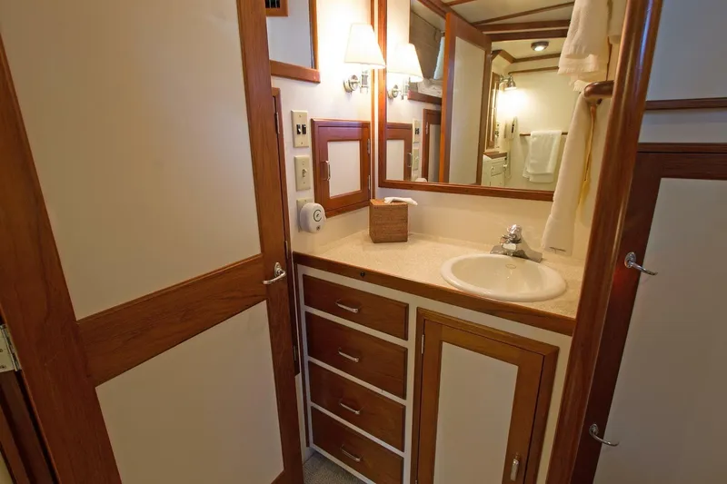 Just Right Yacht Photos Pics Luxurious bathroom interior of 2004 Dettling Express Cruiser with wood accents and modern fixtures.