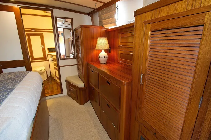 Just Right Yacht Photos Pics Luxurious 2004 Dettling Express Cruiser interior with wooden cabinetry and cozy bedroom.