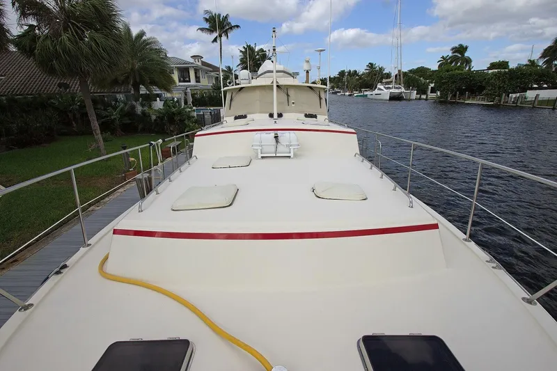 Just Right Yacht Photos Pics 2004 Dettling Express Cruiser on a scenic waterfront with palm trees and blue sky.