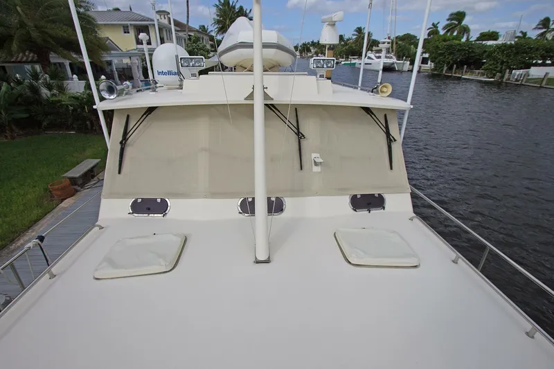 Just Right Yacht Photos Pics 2004 Dettling Express Cruiser docked by a canal, showcasing its deck and equipment.