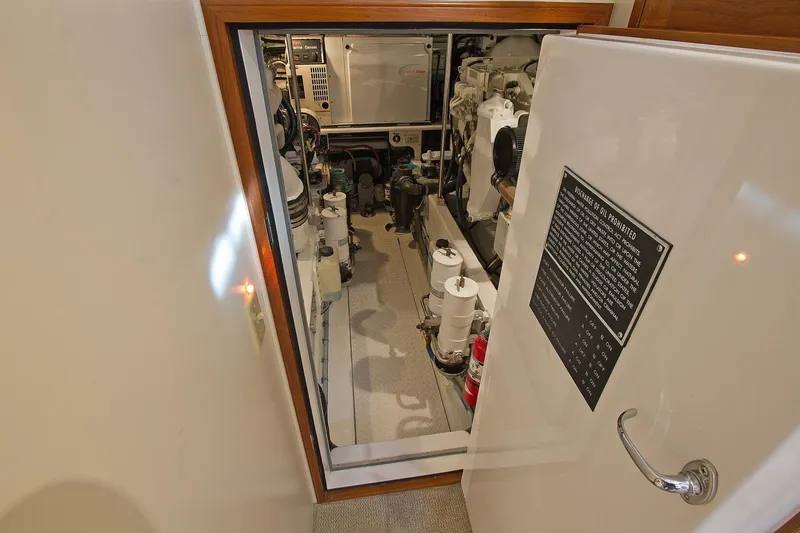 Just Right Yacht Photos Pics Engine room of 2004 Dettling Express Cruiser, showcasing mechanical components and safety instructions.