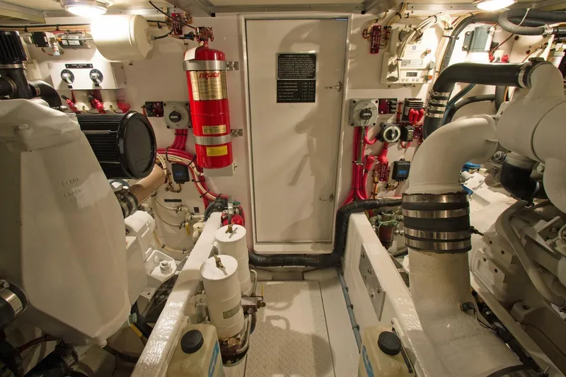 Just Right Yacht Photos Pics Engine room of a 2004 Dettling Express Cruiser, featuring complex machinery and fire safety equipment.