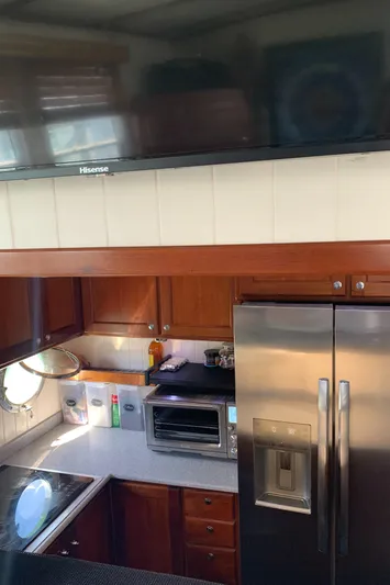 Lazy Days Yacht Photos Pics 2005 Great Harbour GH37 kitchen with stainless steel appliances and wooden cabinetry.