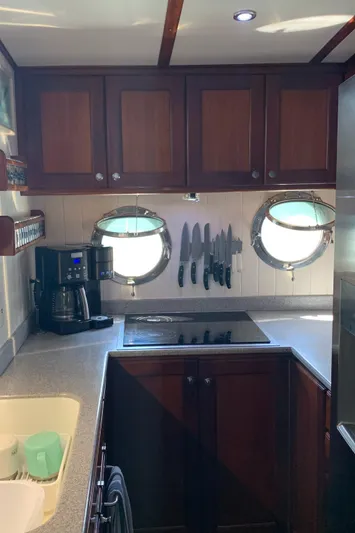 Lazy Days Yacht Photos Pics 2005 Great Harbour GH37 kitchen with wooden cabinets, porthole windows, and modern appliances.