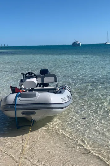 Lazy Days Yacht Photos Pics Inflatable boat on clear beach with Great Harbour GH37 yacht in background, 2005 model.