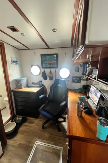 Lazy Days Yacht Photos Pics Office space inside a 2005 Great Harbour GH37 boat with desk, chair, and porthole windows.