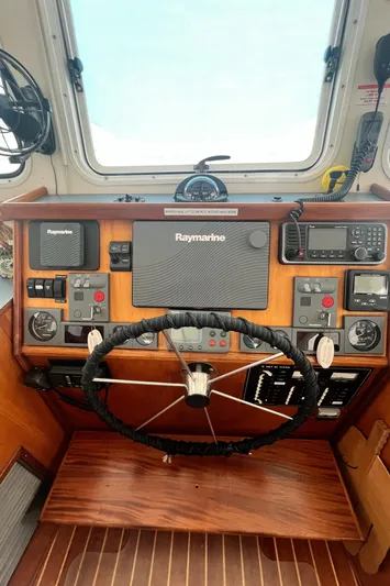 Lazy Days Yacht Photos Pics Great Harbour GH37 2005 helm with Raymarine navigation equipment and wooden steering wheel.