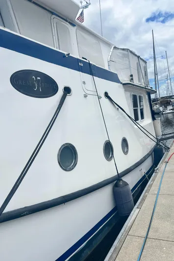 Lazy Days Yacht Photos Pics 2005 Great Harbour GH37 yacht docked at marina, side view with portholes and fender.