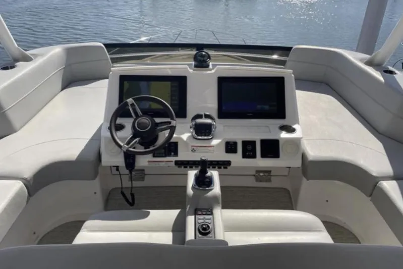 Mi Dia Yacht Photos Pics 2019 Tiara Yachts F53 Flybridge helm with dual screens and modern controls.