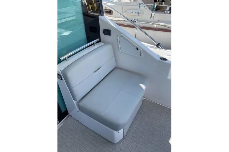 Mi Dia Yacht Photos Pics 2019 Tiara Yachts F53 Flybridge seating area with white cushioned bench.