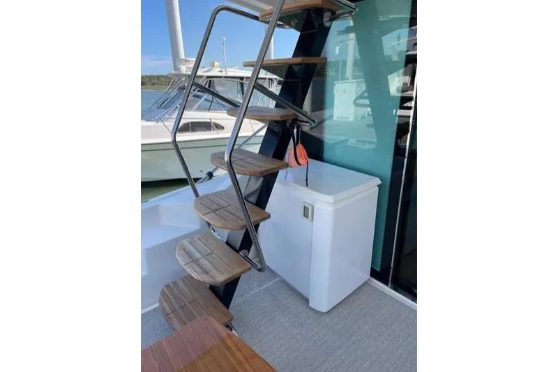 Mi Dia Yacht Photos Pics 2019 Tiara Yachts F53 Flybridge with wooden steps and outdoor storage.