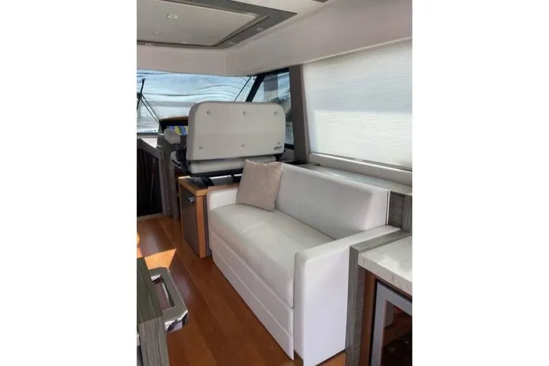 Mi Dia Yacht Photos Pics Luxurious interior of 2019 Tiara Yachts F53 Flybridge with white sofa and modern design.