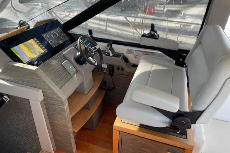 Mi Dia Yacht Photos Pics 2019 Tiara Yachts F53 Flybridge helm with modern controls and navigation display.