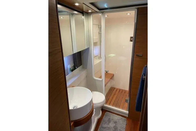 Mi Dia Yacht Photos Pics Luxurious bathroom in 2019 Tiara Yachts F53 Flybridge with modern fixtures and wooden accents.