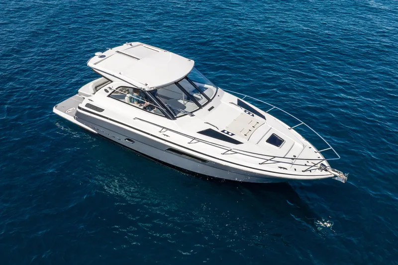 "plymouth Breeze" Yacht Photos Pics 2020 Regal 35 Sport Coupe cruising on clear blue water.