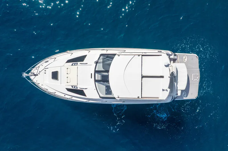 "plymouth Breeze" Yacht Photos Pics 2020 Regal 35 Sport Coupe yacht on clear blue water, aerial view.