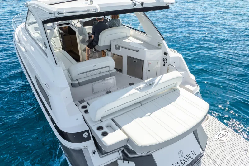 "plymouth Breeze" Yacht Photos Pics 2020 Regal 35 Sport Coupe yacht on clear blue water, rear view.