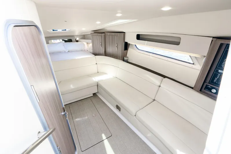 "plymouth Breeze" Yacht Photos Pics 2020 Regal 35 Sport Coupe interior with white seating and modern design.