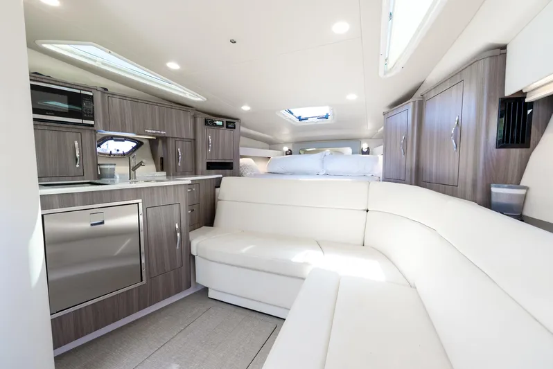 "plymouth Breeze" Yacht Photos Pics Luxurious interior of 2020 Regal 35 Sport Coupe with modern kitchen and seating.