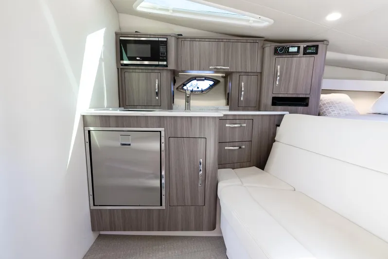 "plymouth Breeze" Yacht Photos Pics 2020 Regal 35 Sport Coupe interior with kitchenette and seating area.