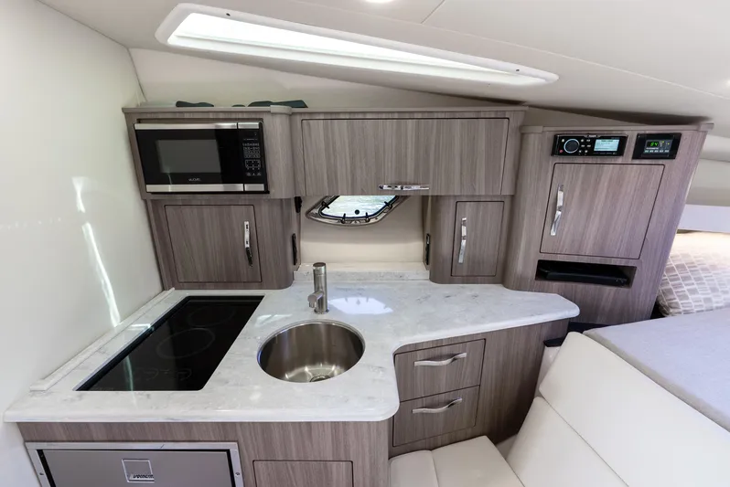 "plymouth Breeze" Yacht Photos Pics 2020 Regal 35 Sport Coupe interior kitchen with modern appliances and sleek cabinetry.