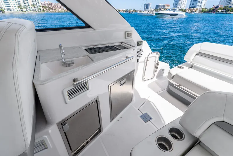 "plymouth Breeze" Yacht Photos Pics 2020 Regal 35 Sport Coupe yacht interior with kitchenette and seating, overlooking water.