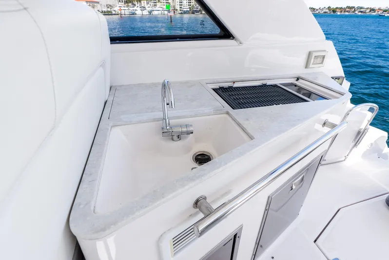 "plymouth Breeze" Yacht Photos Pics 2020 Regal 35 Sport Coupe yacht kitchenette with sink and grill, overlooking water.