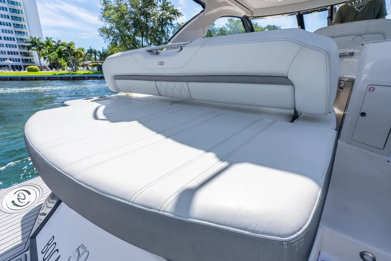 "plymouth Breeze" Yacht Photos Pics 2020 Regal 35 Sport Coupe boat with luxurious white seating and scenic waterfront view.