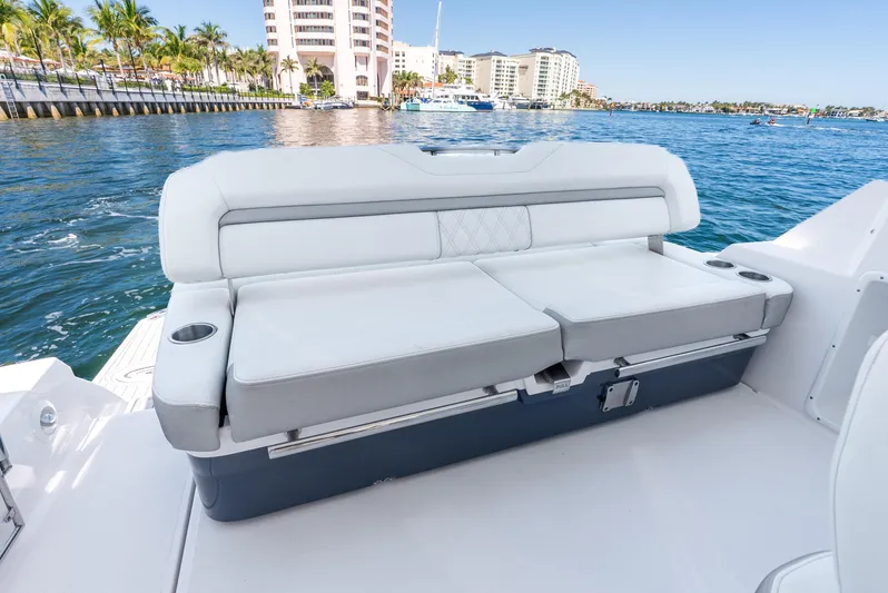 "plymouth Breeze" Yacht Photos Pics 2020 Regal 35 Sport Coupe boat interior with white seating, ocean view, and coastal buildings.