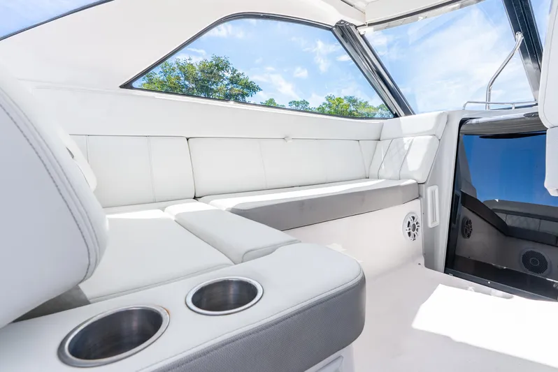 "plymouth Breeze" Yacht Photos Pics 2020 Regal 35 Sport Coupe interior with white seating and cup holders.