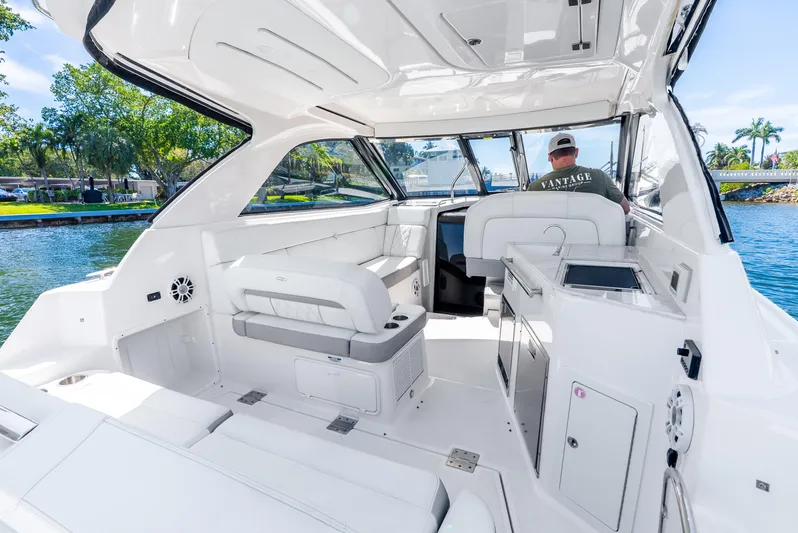 "plymouth Breeze" Yacht Photos Pics 2020 Regal 35 Sport Coupe interior with seating and helm, on a sunny day.