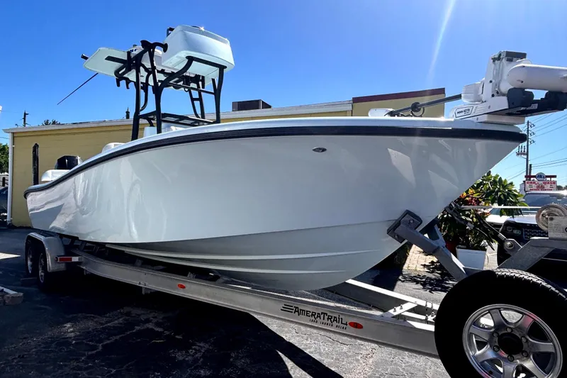  Yacht Photos Pics 2021 Yellowfin 26 Hybrid boat on trailer under clear blue sky.