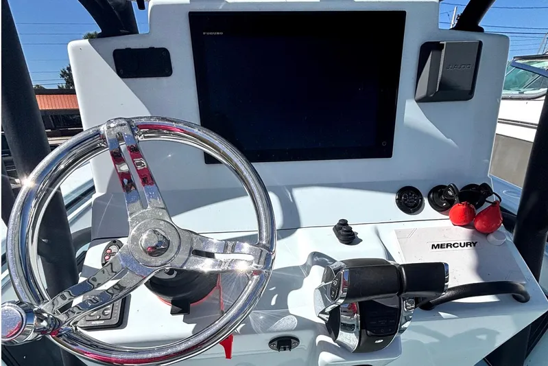  Yacht Photos Pics 2021 Yellowfin 26 Hybrid boat dashboard with steering wheel and Mercury controls.