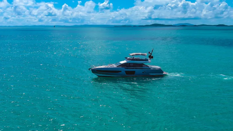 Salina Yacht Photos Pics 2024 Azimut S7 yacht cruising on turquoise ocean under clear blue sky.