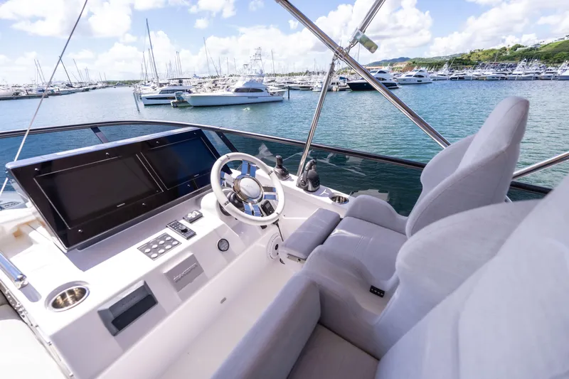 Salina Yacht Photos Pics 2024 Azimut S7 yacht helm with marina view, featuring modern controls and luxurious seating.