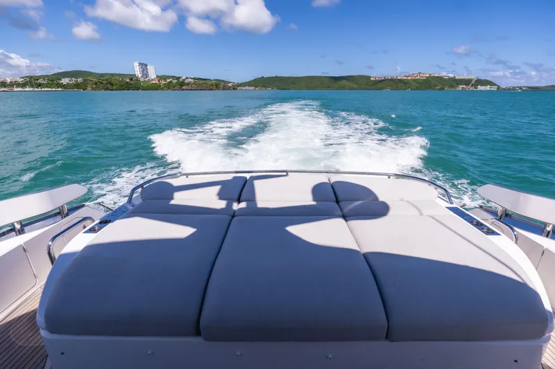 Salina Yacht Photos Pics 2024 Azimut S7 yacht cruising on blue ocean with scenic coastal view.