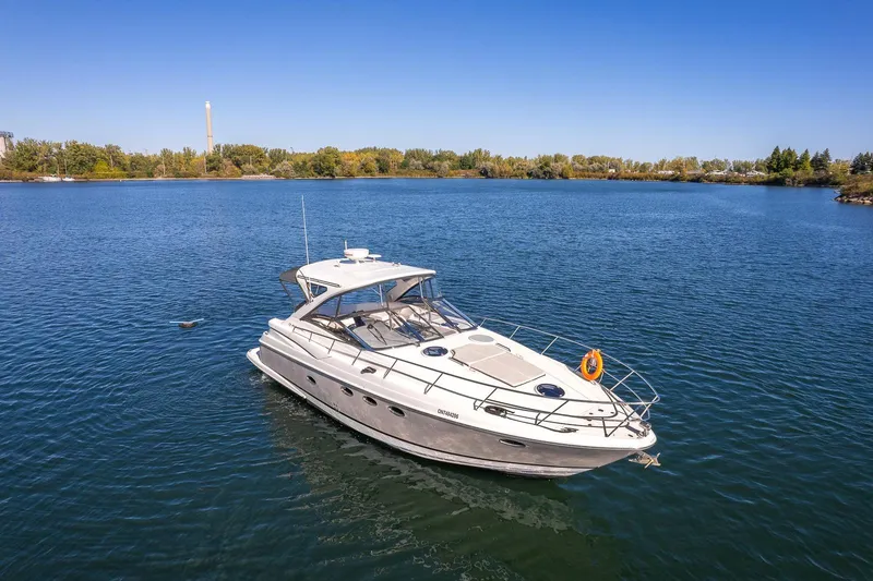  Yacht Photos Pics 2009 Regal Commodore 4060 yacht on a serene lake under clear blue skies.