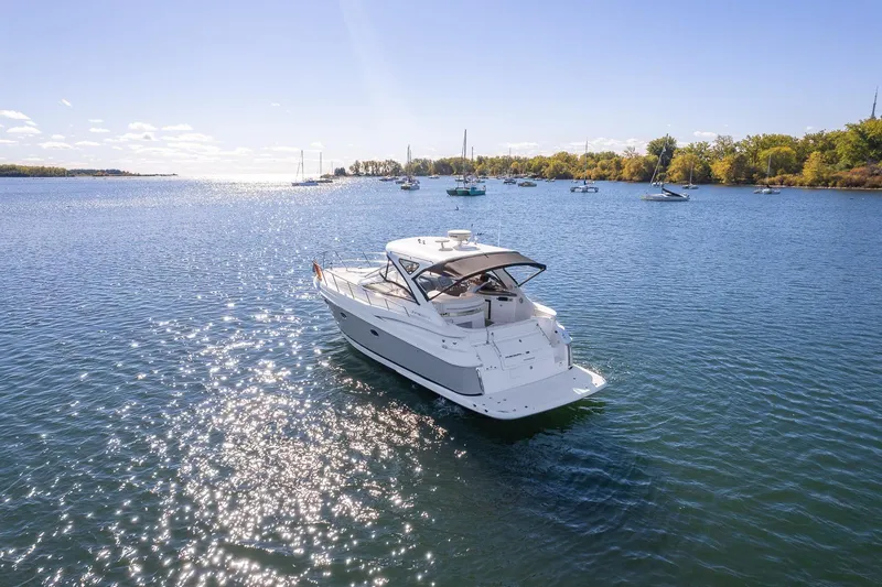  Yacht Photos Pics 2009 Regal Commodore 4060 yacht cruising on a sunny lake with other boats nearby.
