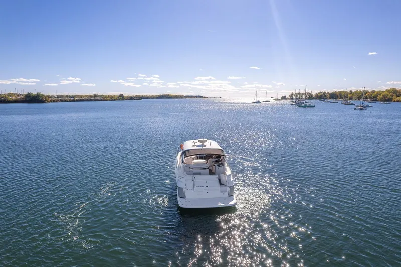  Yacht Photos Pics 2009 Regal Commodore 4060 yacht cruising on a sunny, tranquil lake.