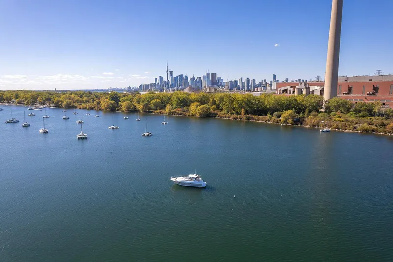  Yacht Photos Pics 2009 Regal Commodore 4060 yacht on a serene lake with city skyline in the background.