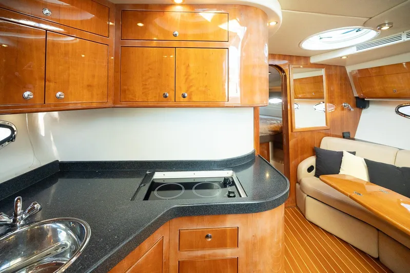  Yacht Photos Pics Luxurious 2009 Regal Commodore 4060 yacht interior with modern kitchen and cozy seating area.