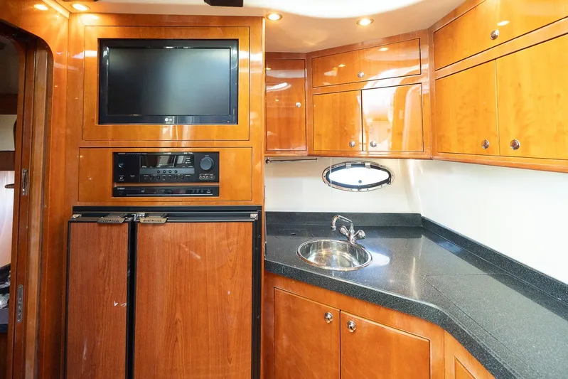  Yacht Photos Pics Luxurious 2009 Regal Commodore 4060 yacht kitchen with wood cabinets and modern appliances.
