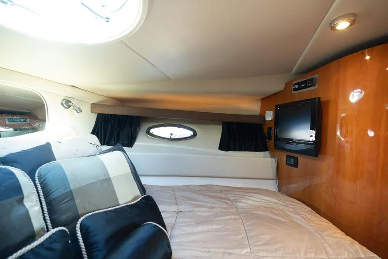  Yacht Photos Pics Luxurious cabin interior of 2009 Regal Commodore 4060 yacht with cozy bedding and TV.