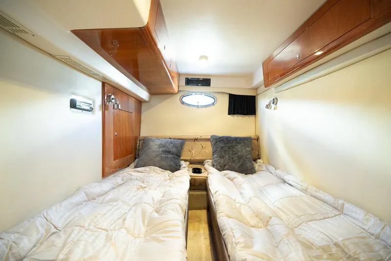 Yacht Photos Pics Interior cabin of 2009 Regal Commodore 4060 yacht with twin beds and wooden cabinetry.