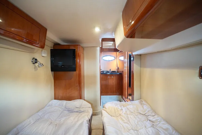  Yacht Photos Pics 2009 Regal Commodore 4060 cabin interior with twin beds and wooden cabinetry.